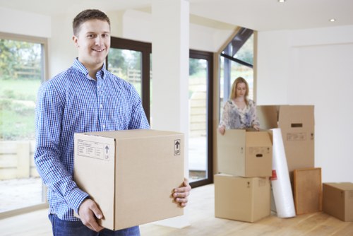 Household move preparation with labelled boxes and wrapped furniture