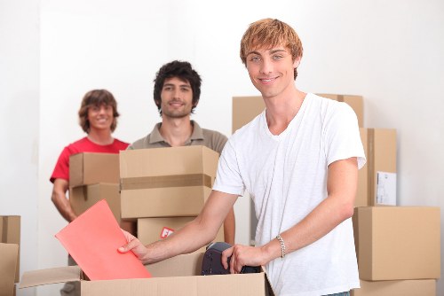 Professional movers carrying boxes inside a Marylebone apartment building